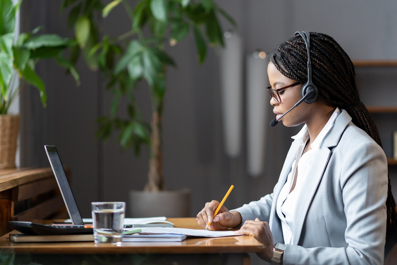 Woman Wearing a Headset at a Work Desk 