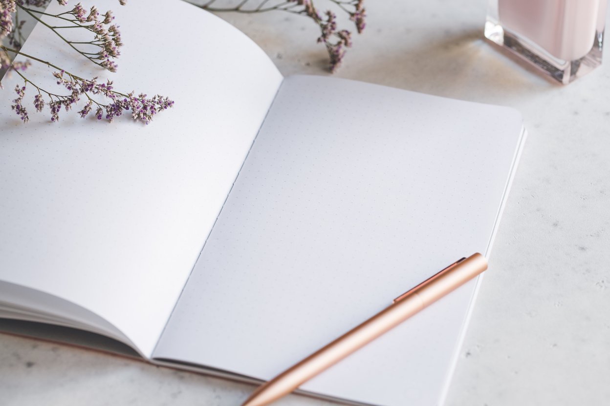 Open Blank Notebook and Pen on Feminine Desk